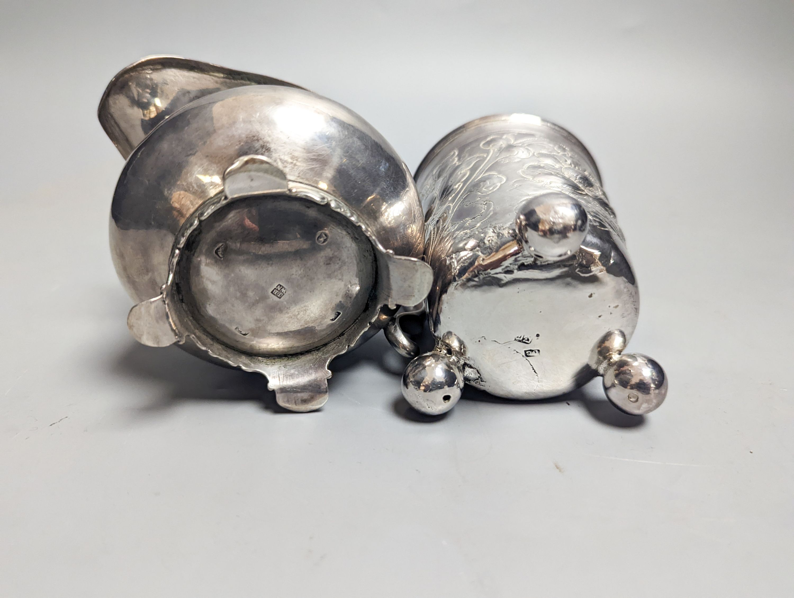 A William IV provincial silver cream jug, Barber & North, York?, 1836 and an 18th century continental embossed white metal beaker(a.f.), gross 6.5oz.